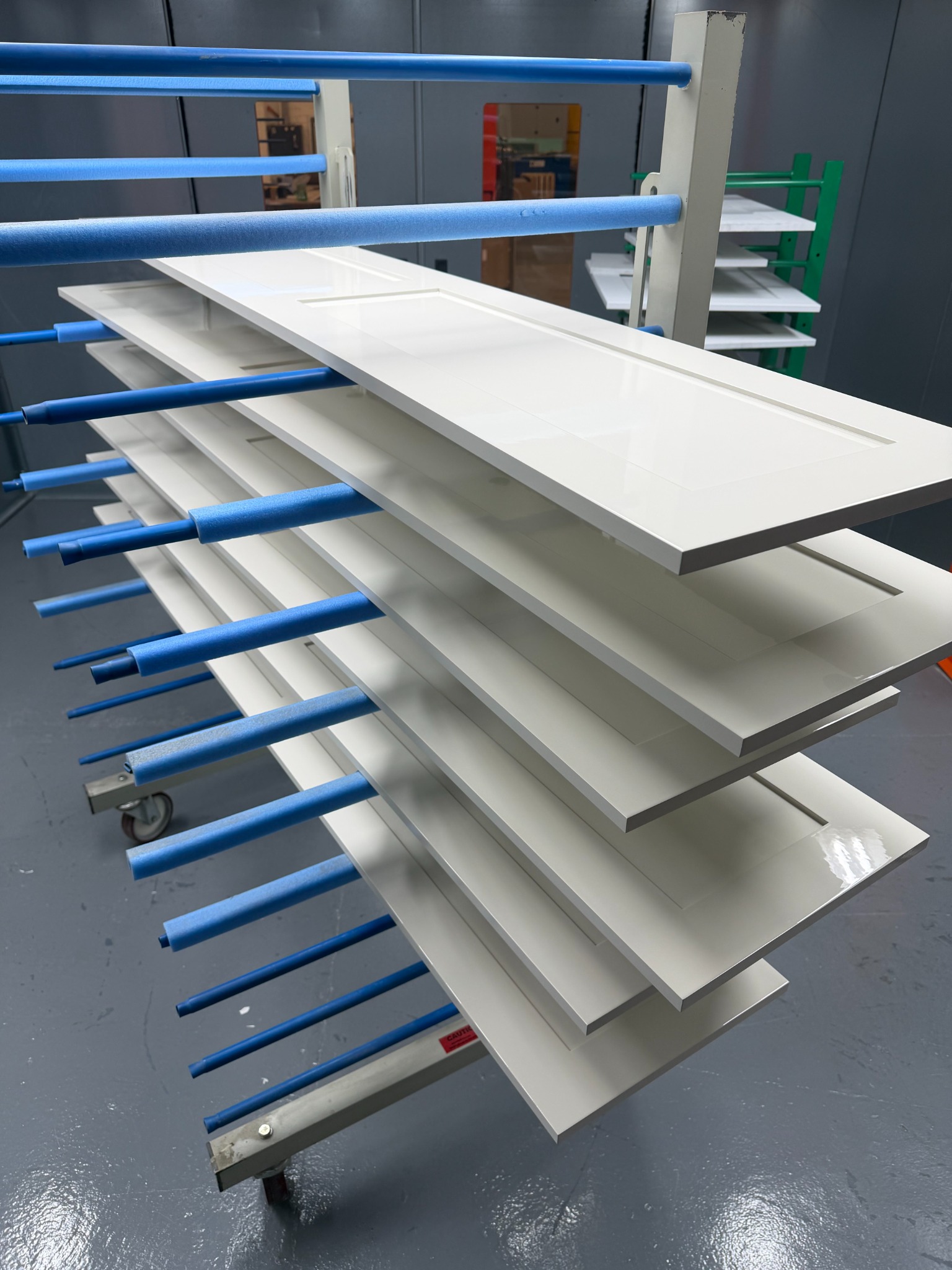 White spray-finished bespoke doors in the PaintSpray workshop